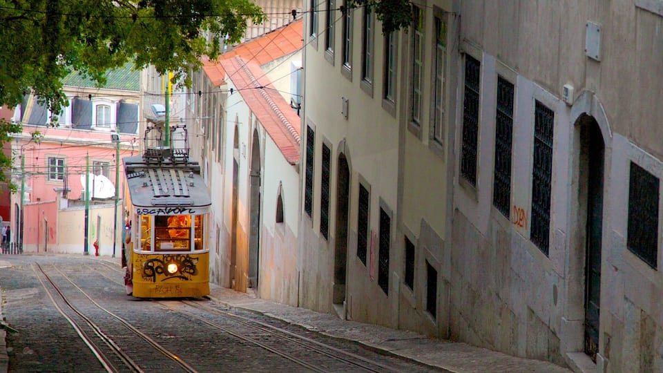 A yellow tram on a narrow street with buildings on either side.