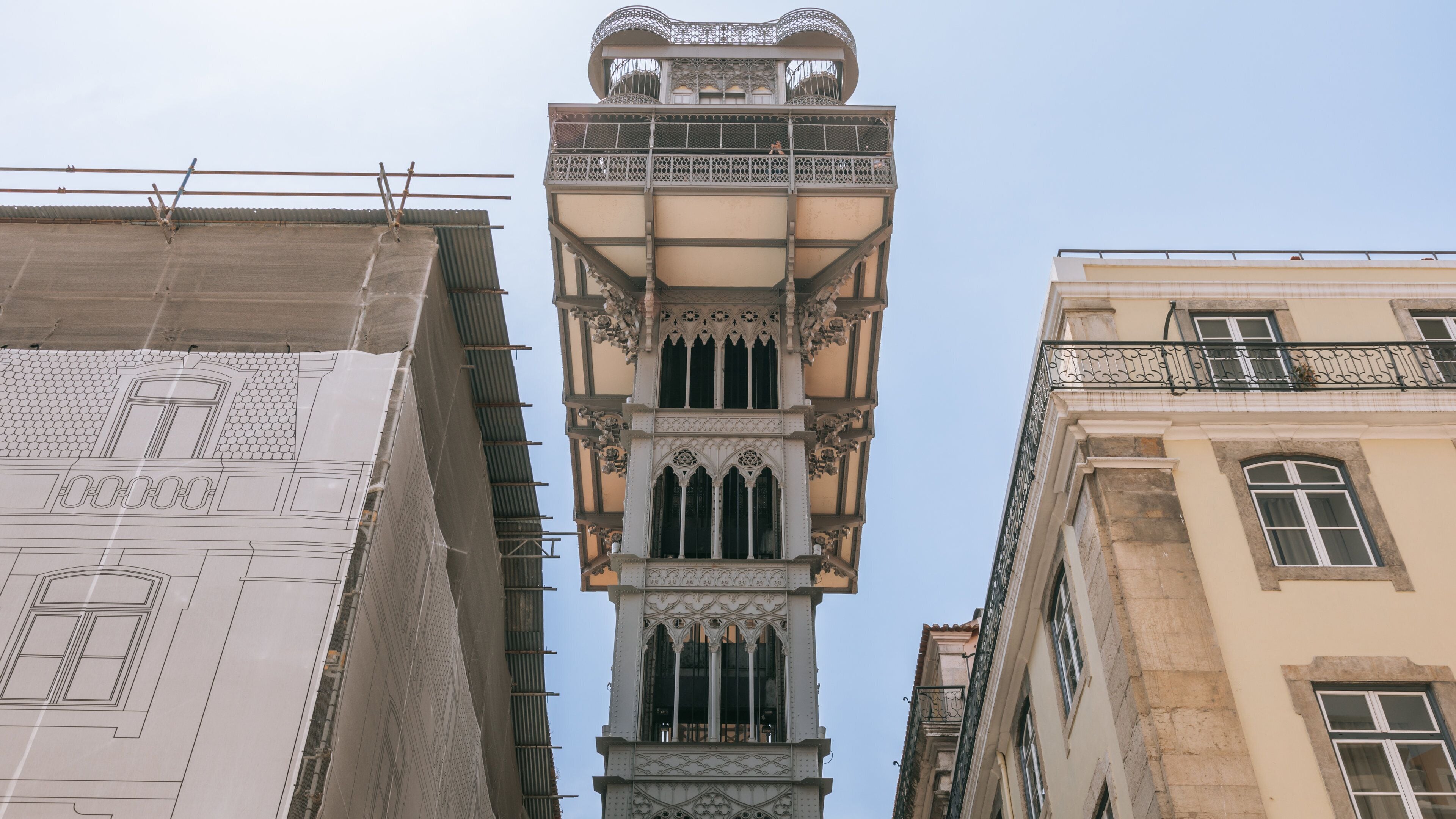 A historic tower with intricate architectural details, including ornate balconies and a spire.