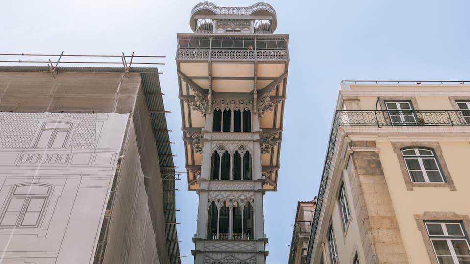 A historic tower with intricate architectural details, including ornate balconies and a spire.