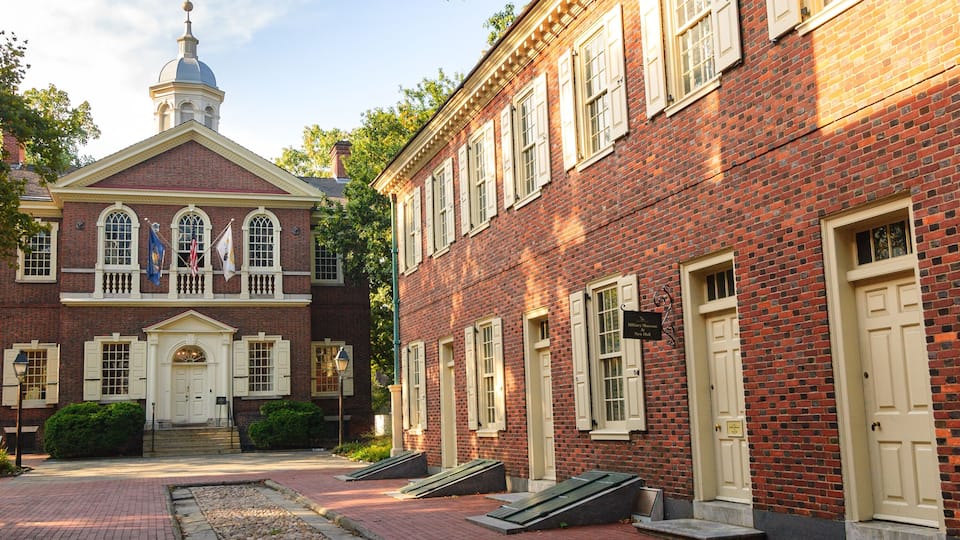 A historic building with a central dome and a brick facade.