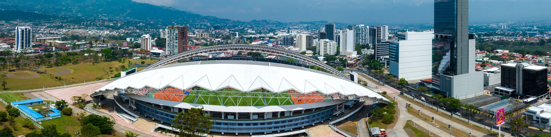 View of the National Stadium of Costa Rica. San Jose, Costa rica capital city street view with mountains in the background.