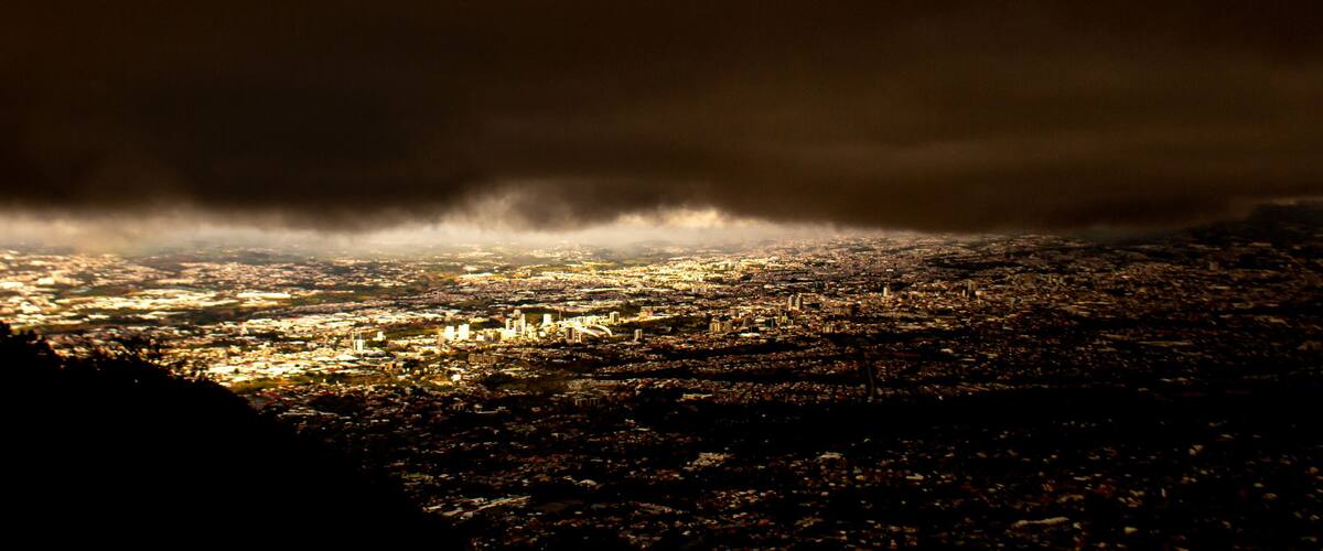 A cityscape under a stormy sky.