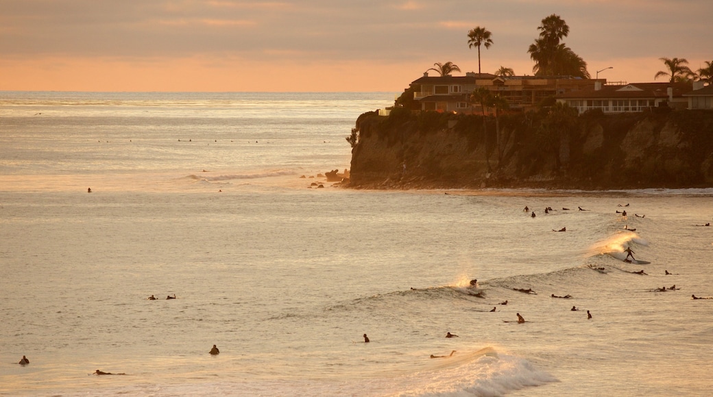 Pacific Beach Park showing surfing, swimming and rugged coastline