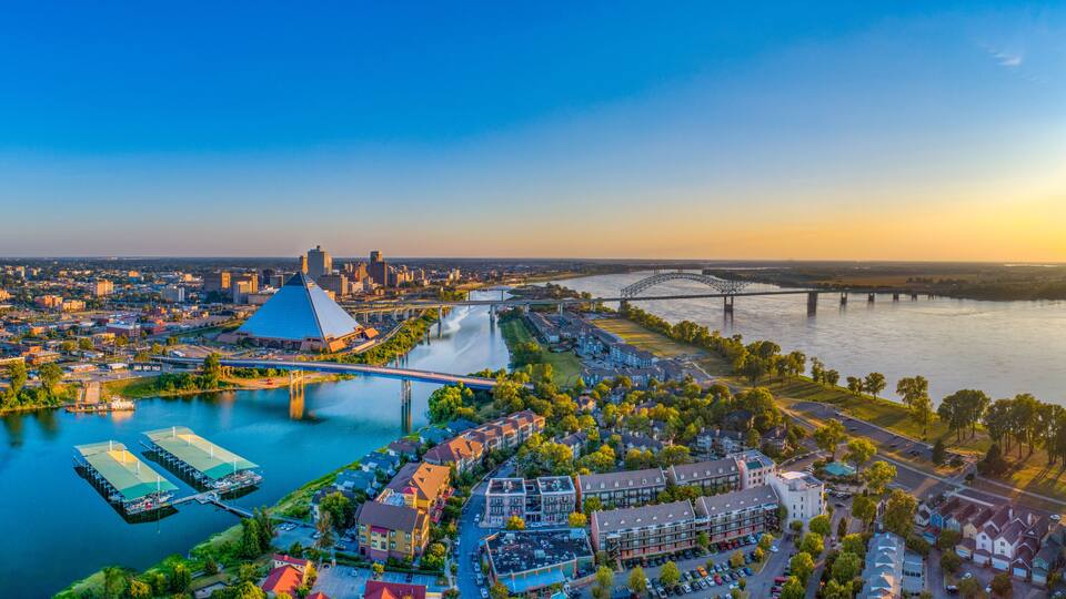 A river with bridges, a stadium, and residential buildings.