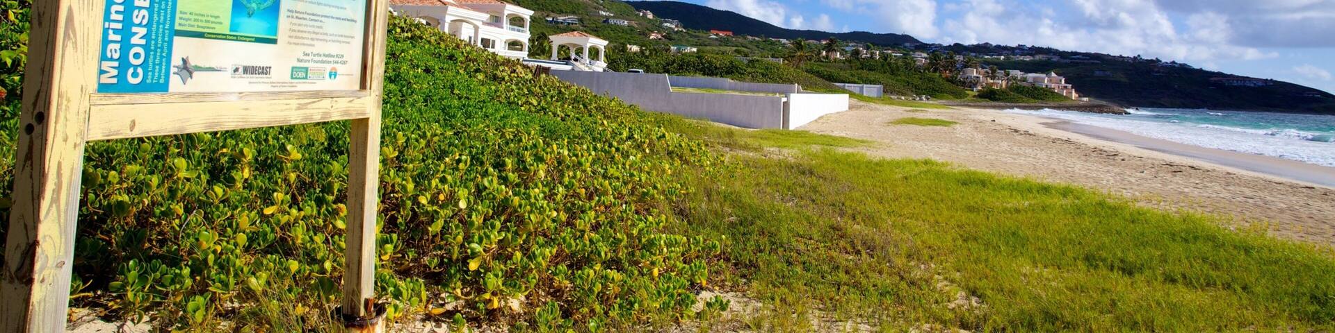 Guana Bay Beach featuring a beach, signage and landscape views