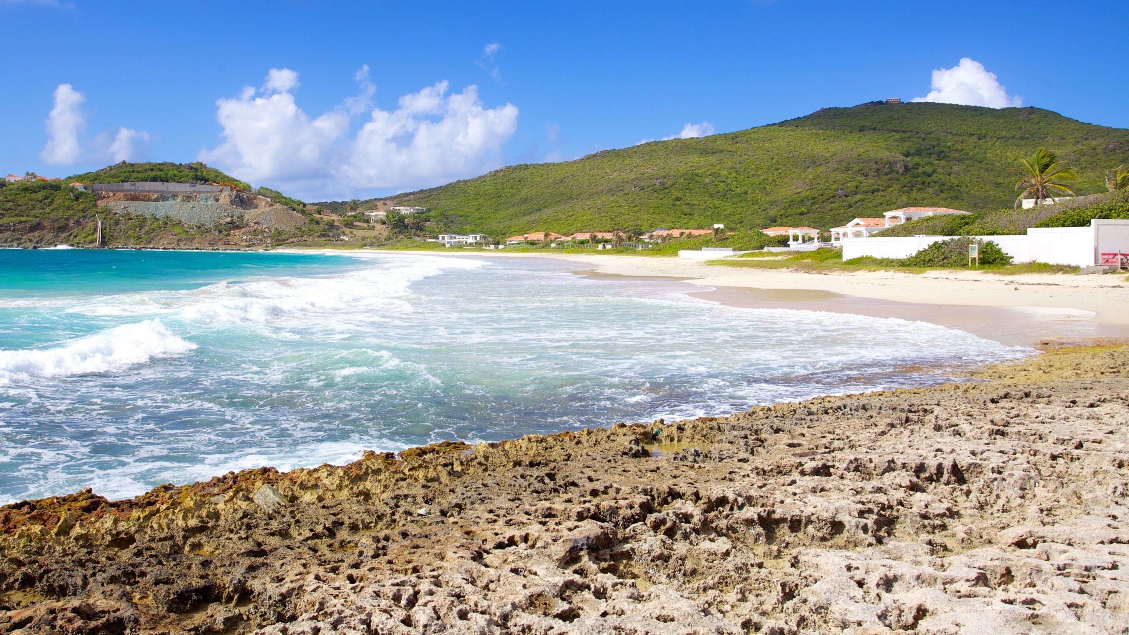 Guana Bay Beach showing a sandy beach, a coastal town and landscape views