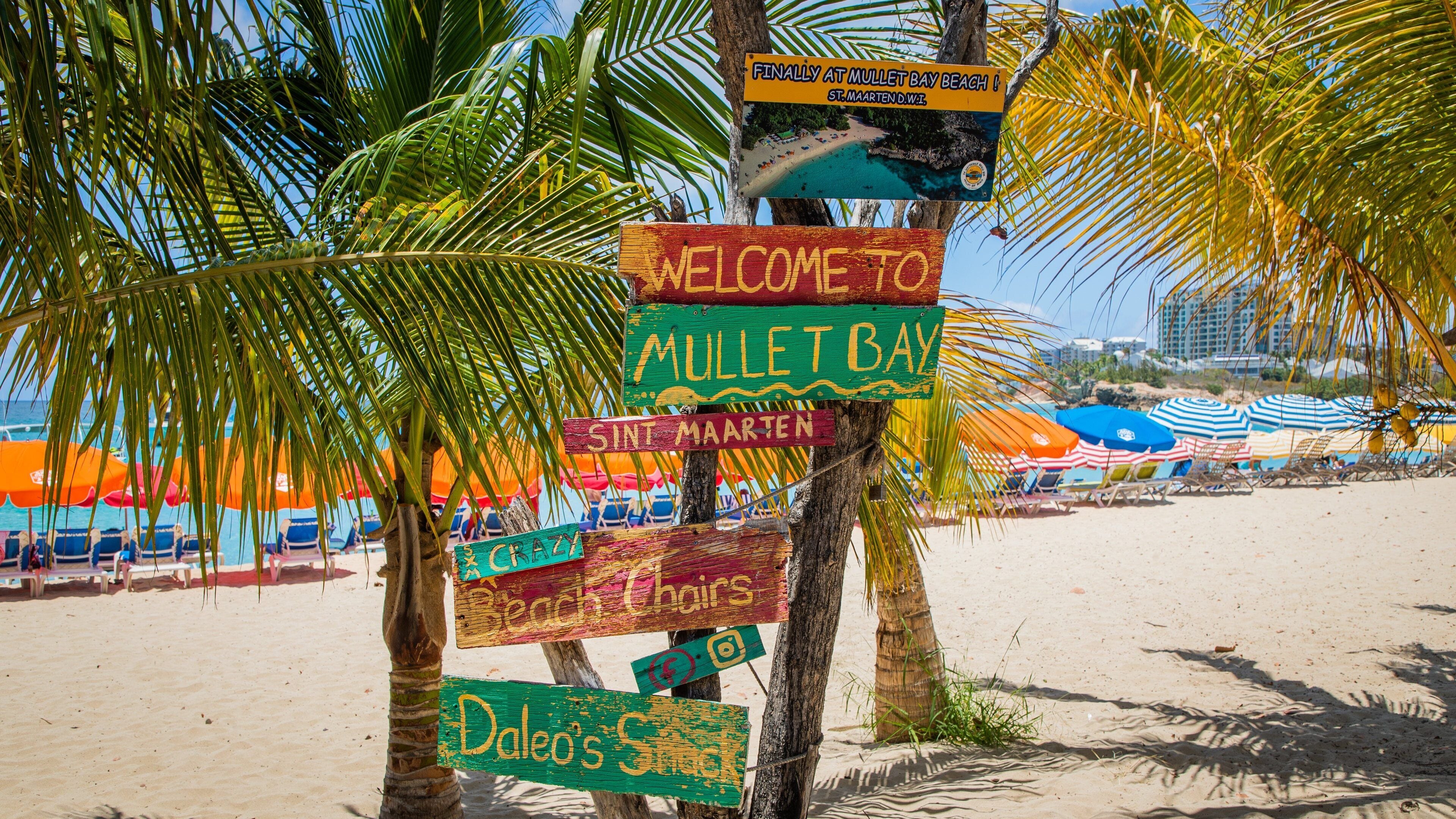 Mullet Bay Beach showing signage and a sandy beach