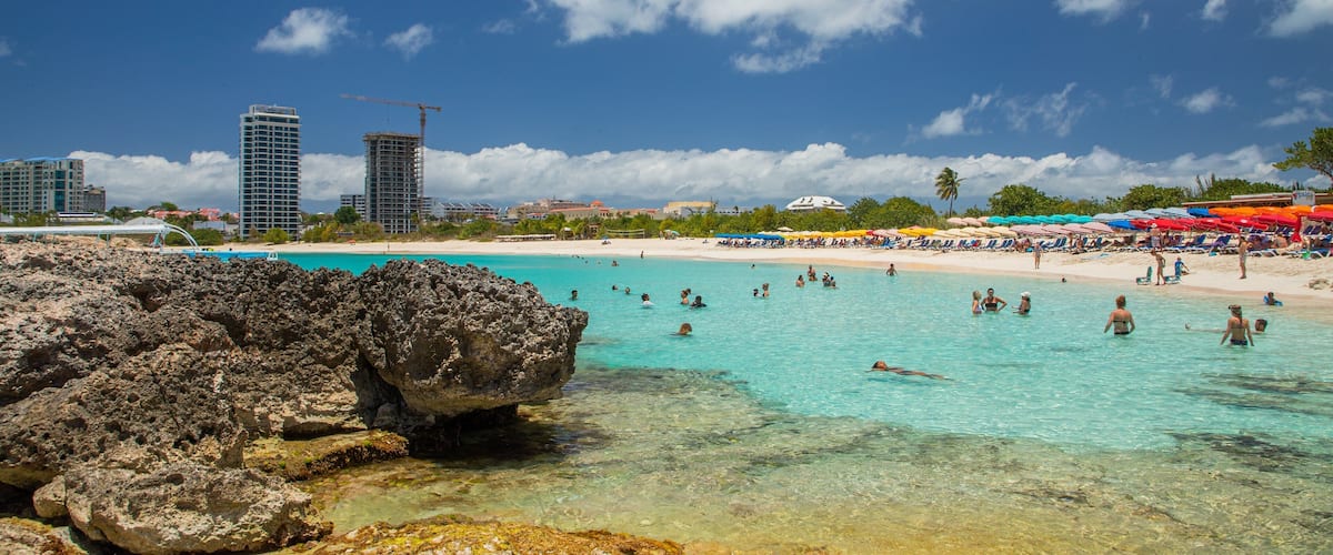 Mullet Bay Beach which includes a sandy beach, swimming and general coastal views