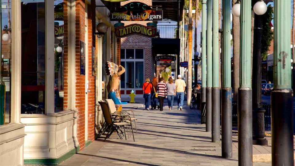 Ybor City featuring signage as well as a family