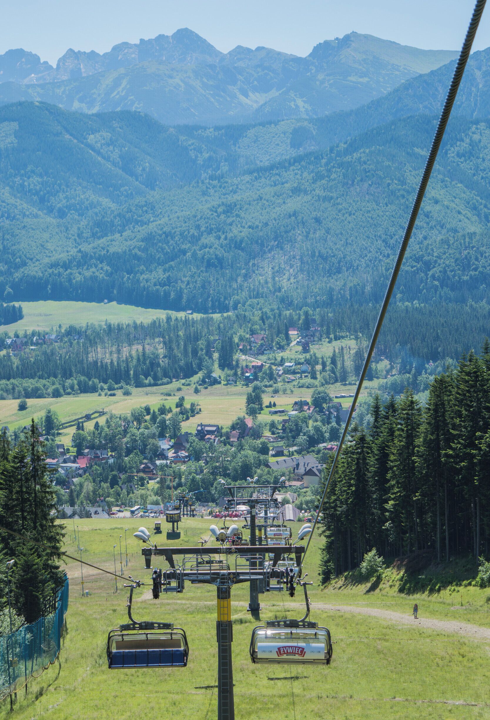 A cable car system with a mountainous landscape in the background.