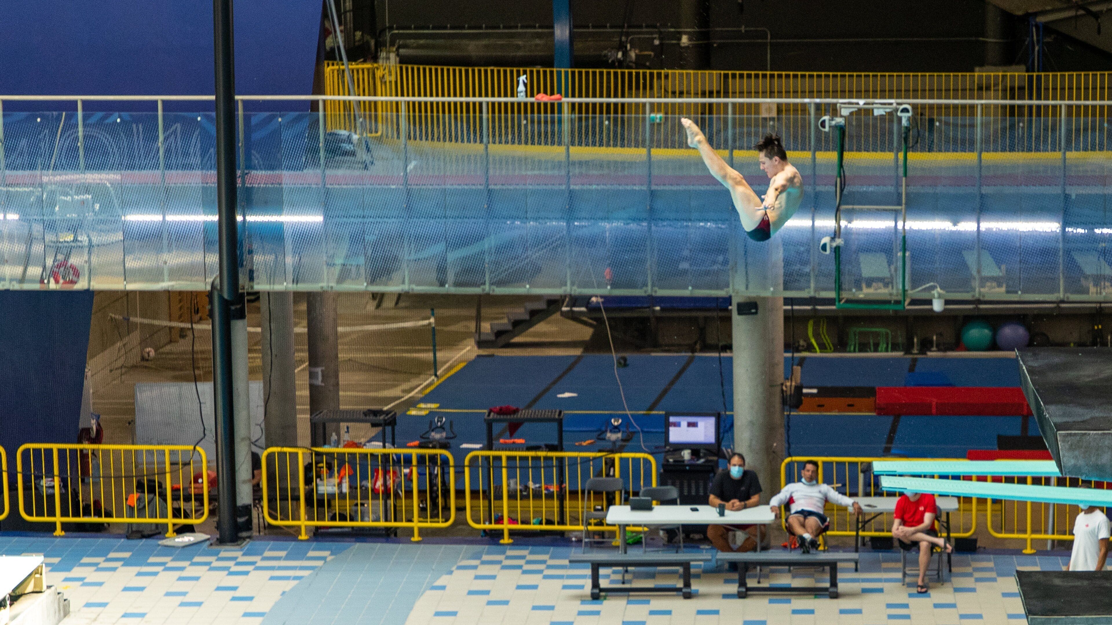 Olympic Park featuring interior views and swimming as well as an individual male