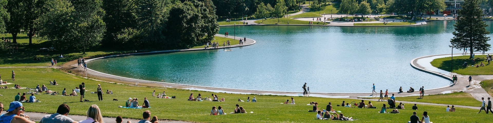 Mount Royal Park featuring a park and a pond as well as a small group of people