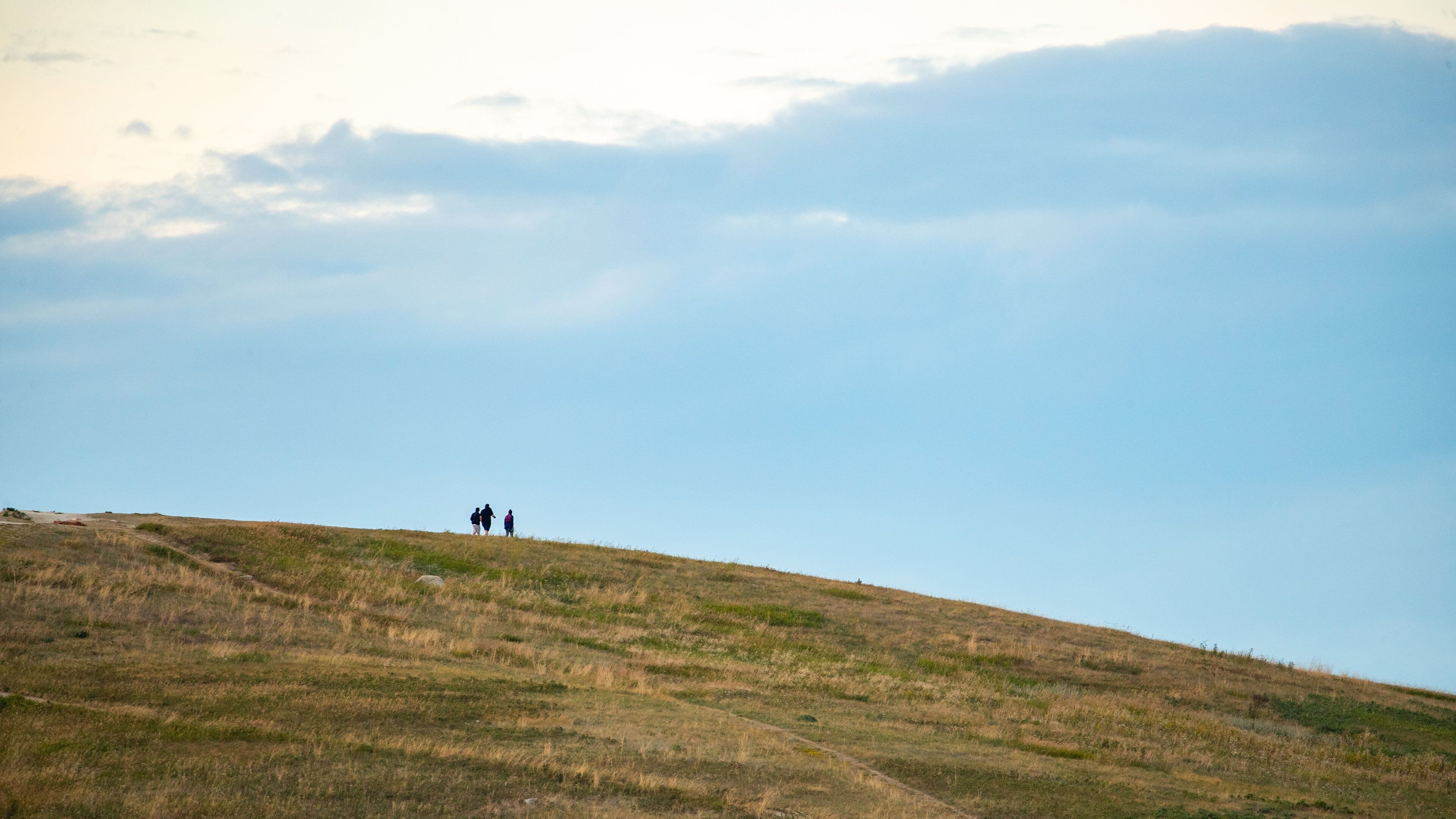 Nose Hill Park featuring tranquil scenes as well as a small group of people