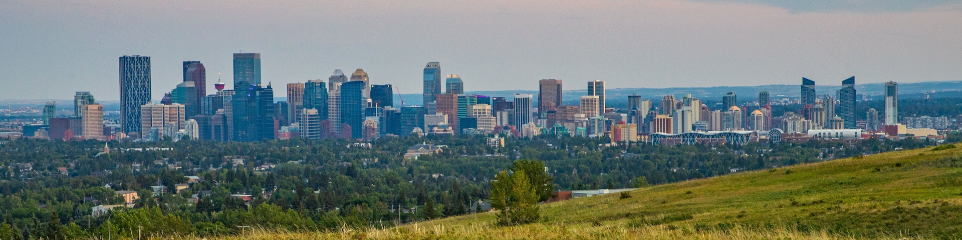Nose Hill Park showing landscape views, a city and a sunset