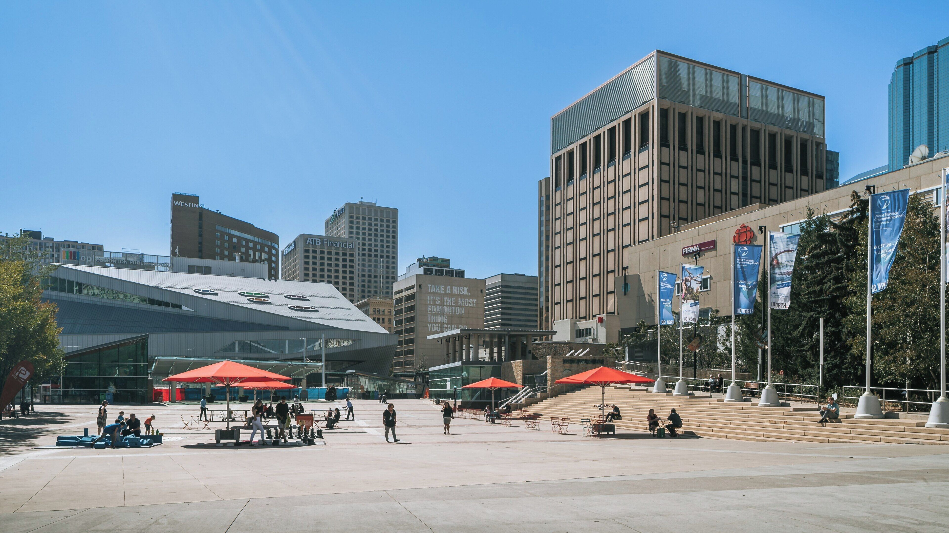 Visit to Sir Winston Churchill Square in Downtown Edmonton on a sunny day with people enjoying the space and vibrant city atmosphere
