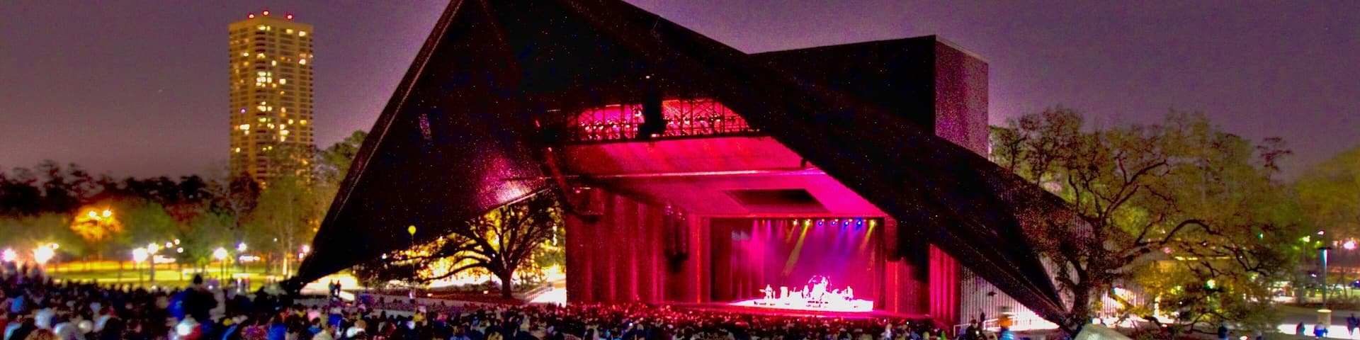 Hermann Park showing performance art, night scenes and a park