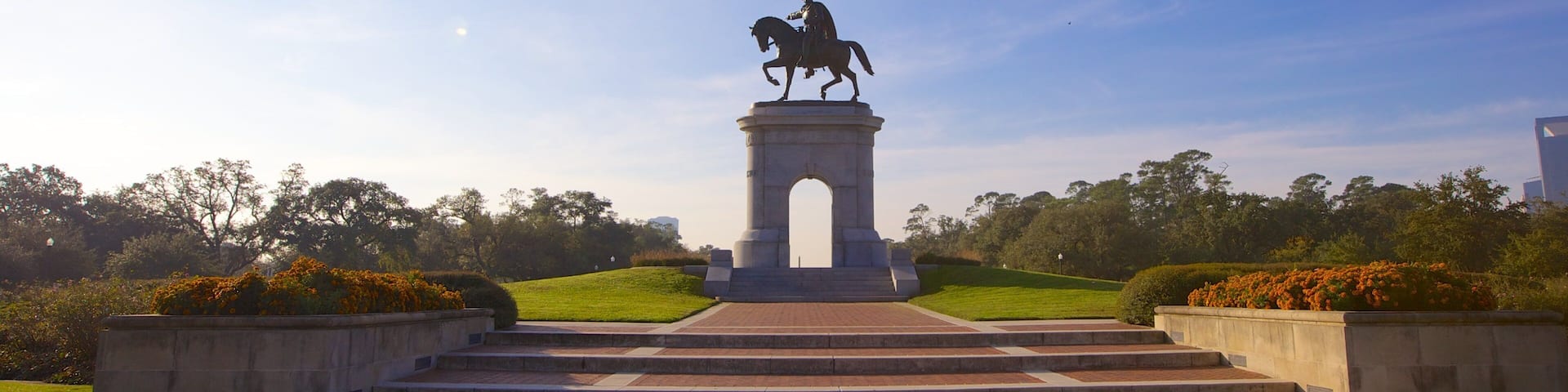 Statue of a rider on horseback stands proudly in Hermann Park, Houston under clear skies