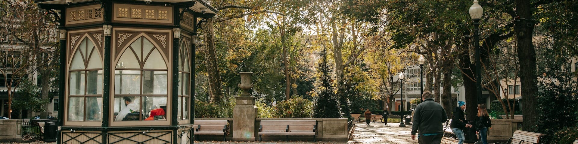 A park with a gazebo, benches, and trees.