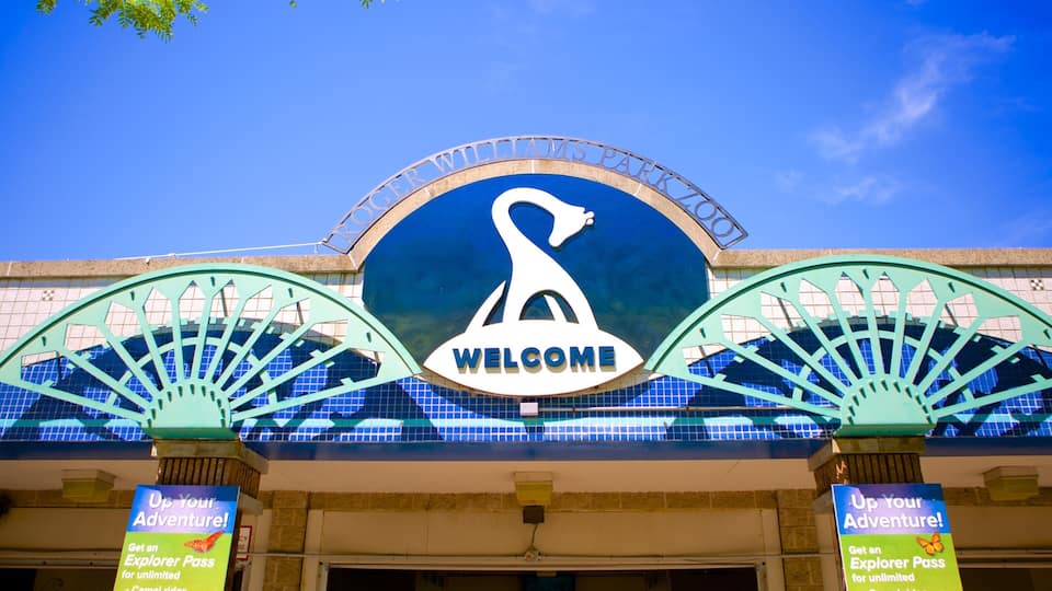 A large welcome sign with a swan logo above it.