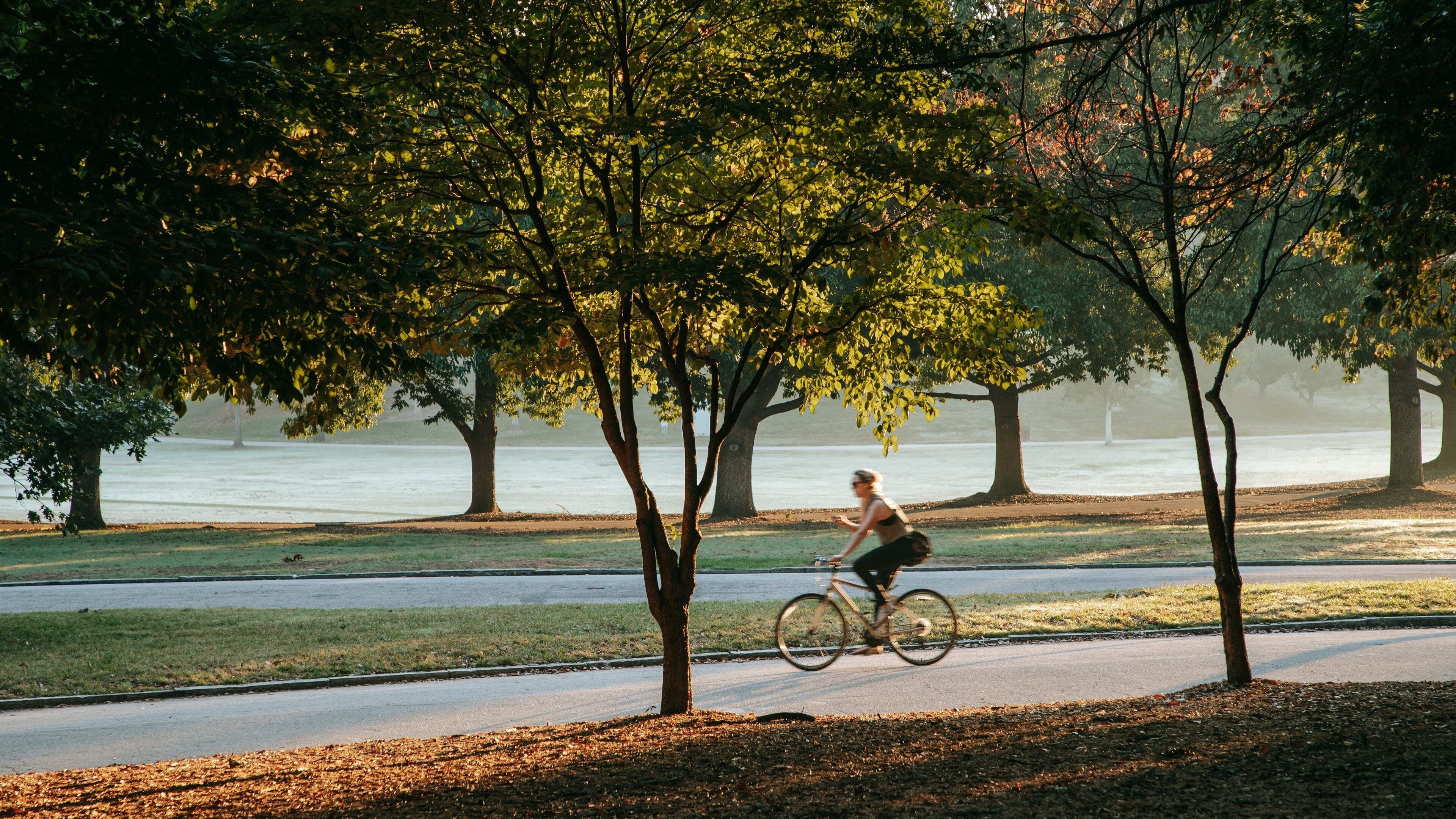 Piedmont Park featuring cycling and a garden as well as an individual femail
