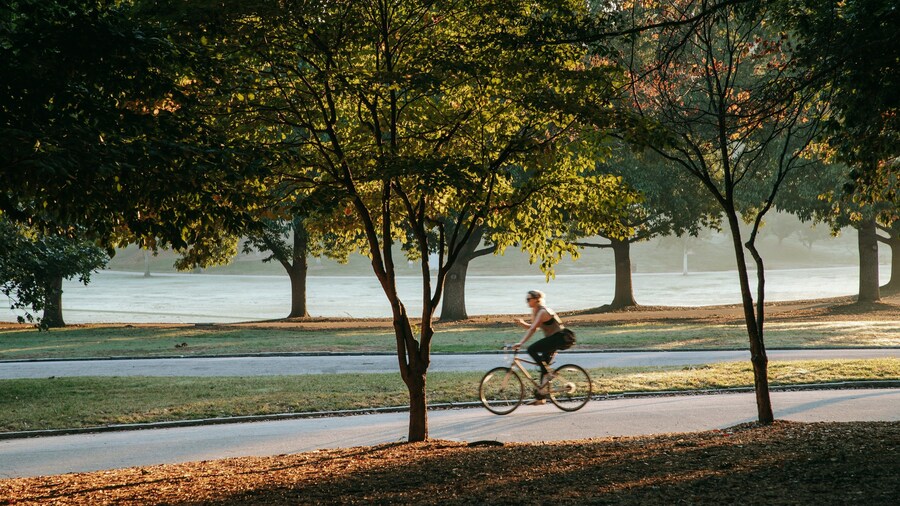 Piedmont Park featuring cycling and a garden as well as an individual femail