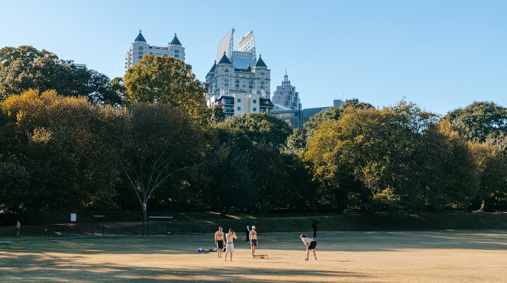 Piedmont Park featuring a garden as well as a small group of people