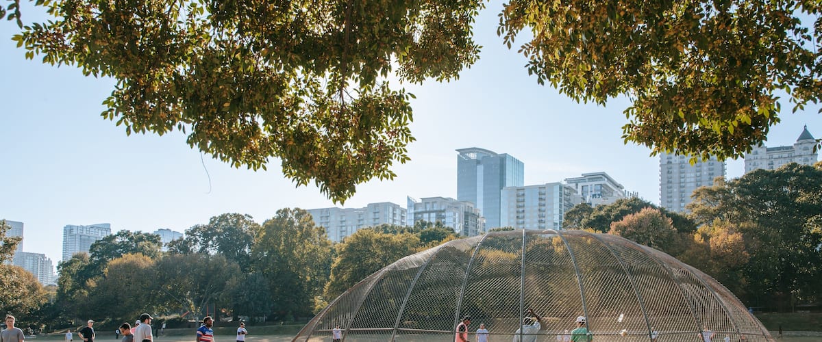 Piedmont Park as well as a small group of people