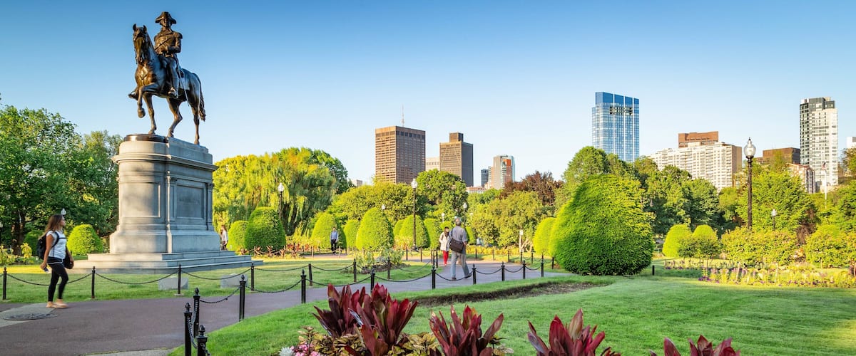 Boston Public Garden showing a statue or sculpture, a garden and flowers