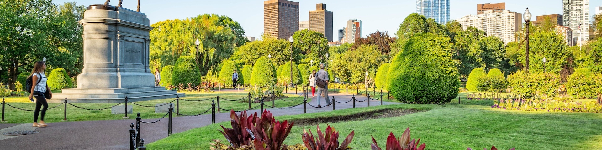 Boston Public Garden showing a statue or sculpture, a garden and flowers