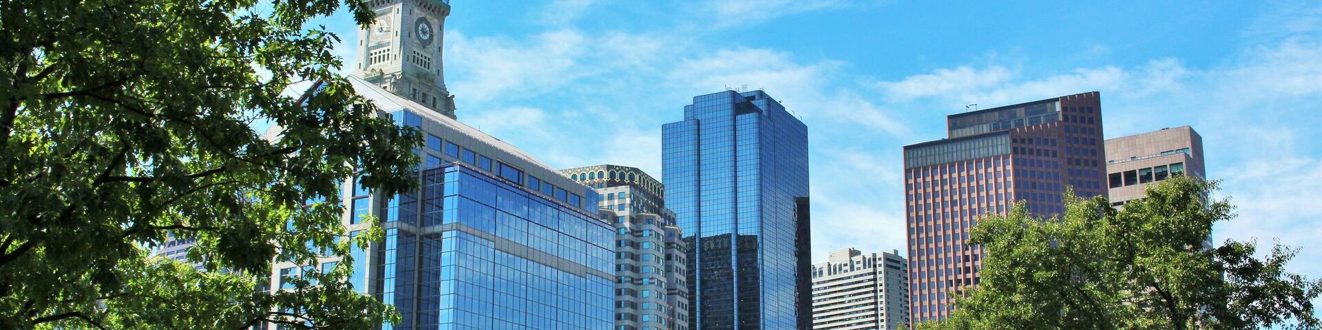 Christopher Columbus Park in Boston, MA on a sunny summer day with Boston skyline and clock tower in the background