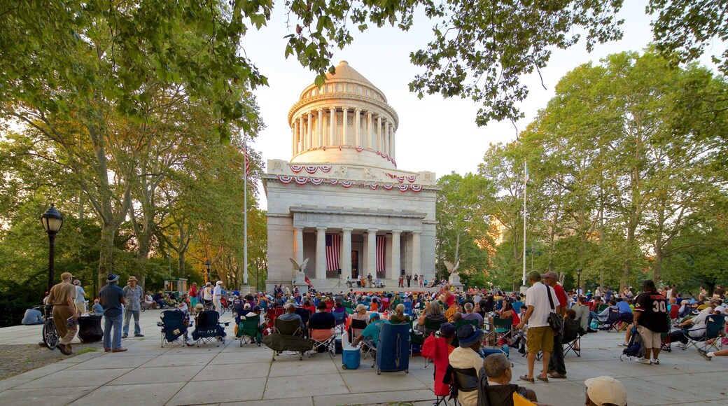 Riverside Park featuring heritage architecture and a square or plaza as well as a large group of people