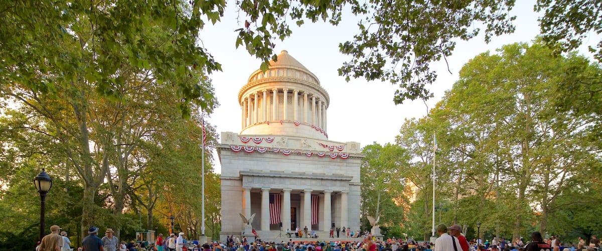 Riverside Park featuring heritage architecture and a square or plaza as well as a large group of people