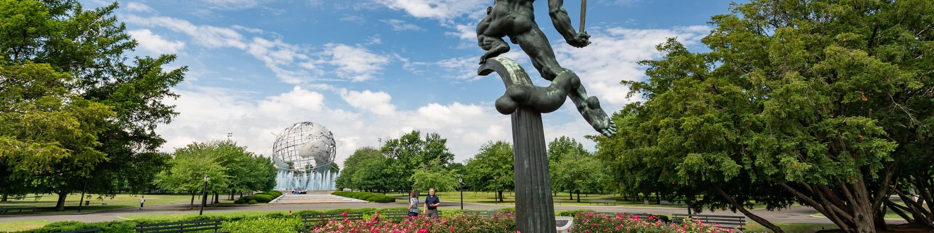 Flushing Meadows-Corona Park featuring flowers, a statue or sculpture and a park