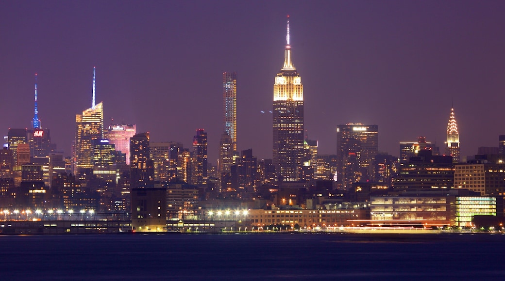 Liberty State Park featuring a river or creek, a high rise building and night scenes
