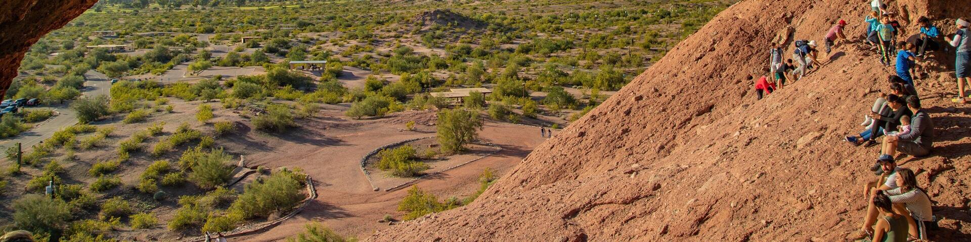 Papago Park featuring desert views as well as a small group of people