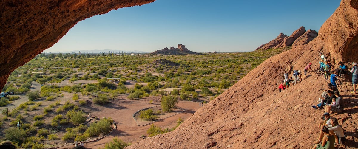 Papago Park featuring desert views as well as a small group of people