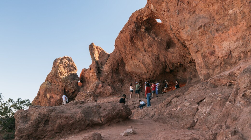 Papago Park showing a gorge or canyon as well as a small group of people