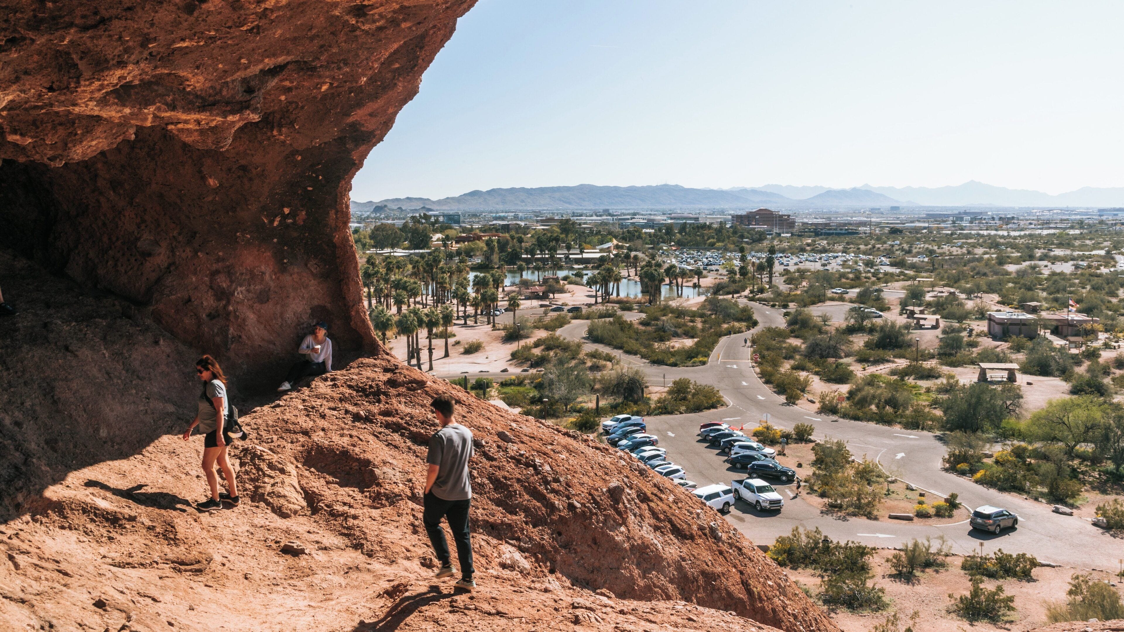 Visitors exploring the rocky terrain and unique formations of Papago Park in Camelback East, Phoenix, Arizona during a sunny day
