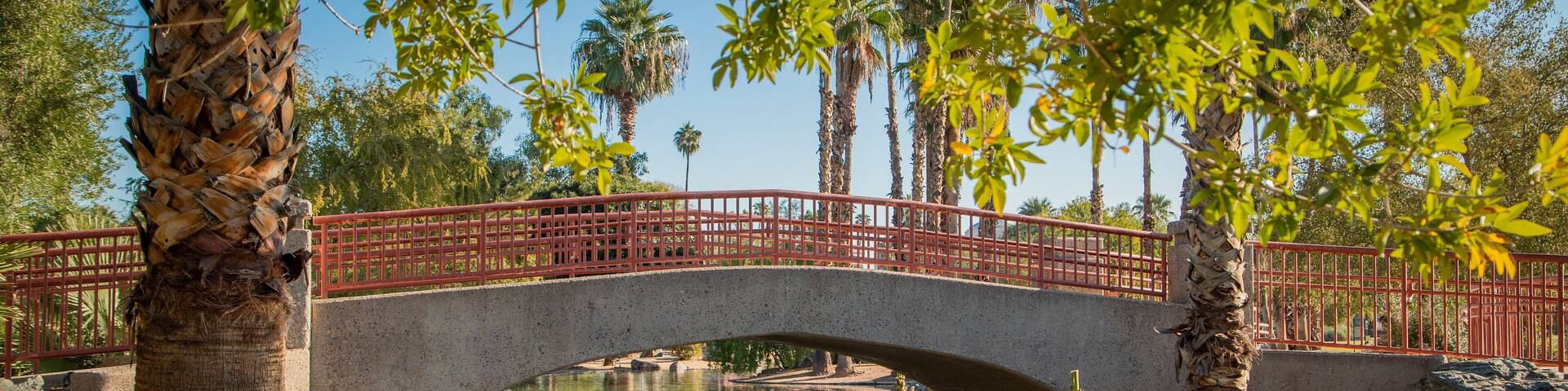 Encanto Park which includes a river or creek and a bridge