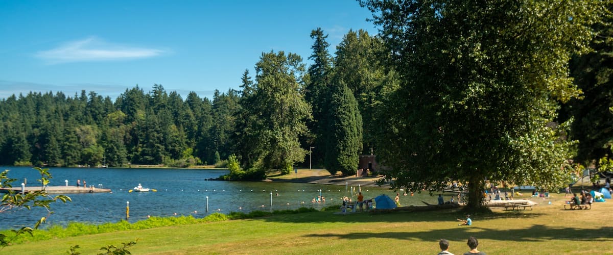Seward Park featuring a garden and a lake or waterhole as well as a couple