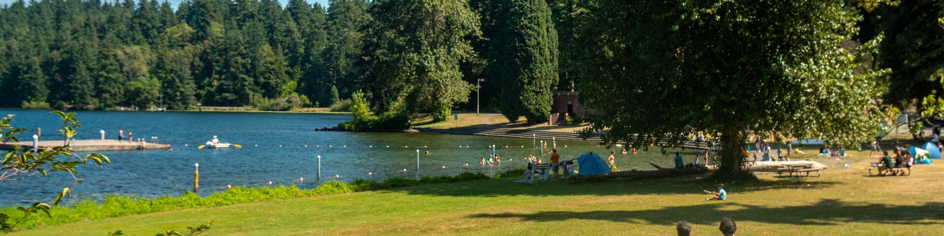 Seward Park featuring a garden and a lake or waterhole as well as a couple