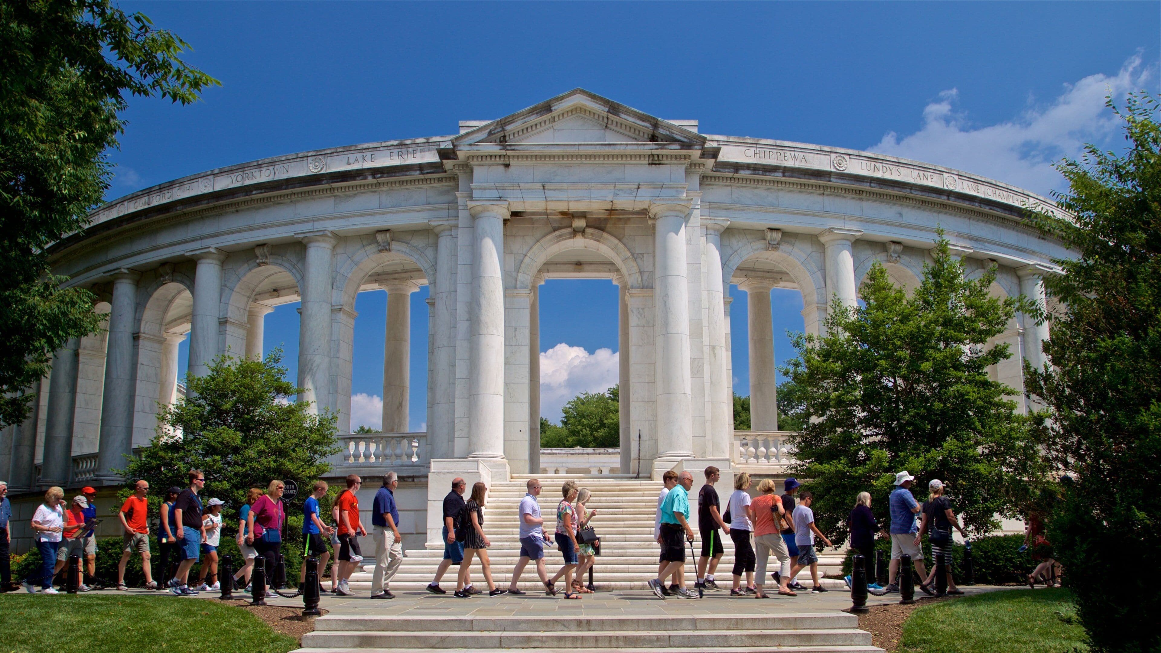 Arlington National Cemetery featuring heritage architecture as well as a small group of people