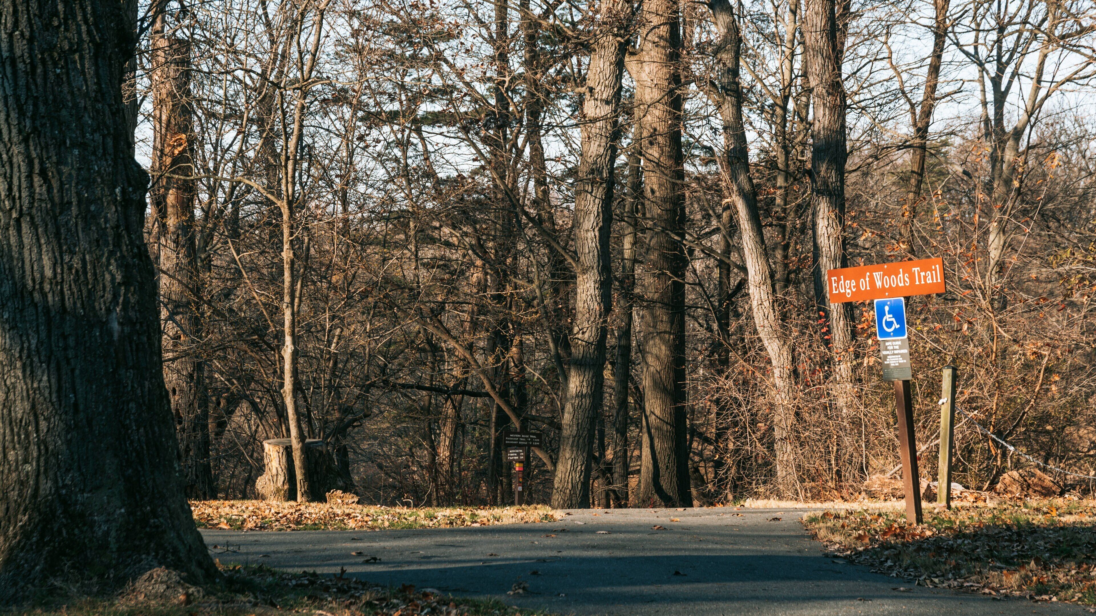 Rock Creek Park featuring tranquil scenes and signage