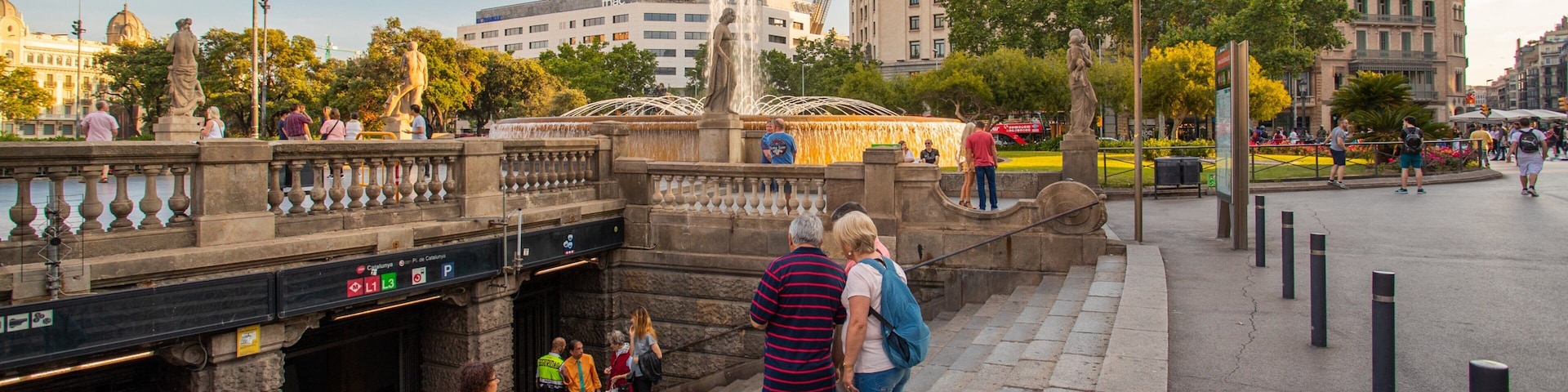 Placa de Catalunya showing a city and street scenes as well as a small group of people