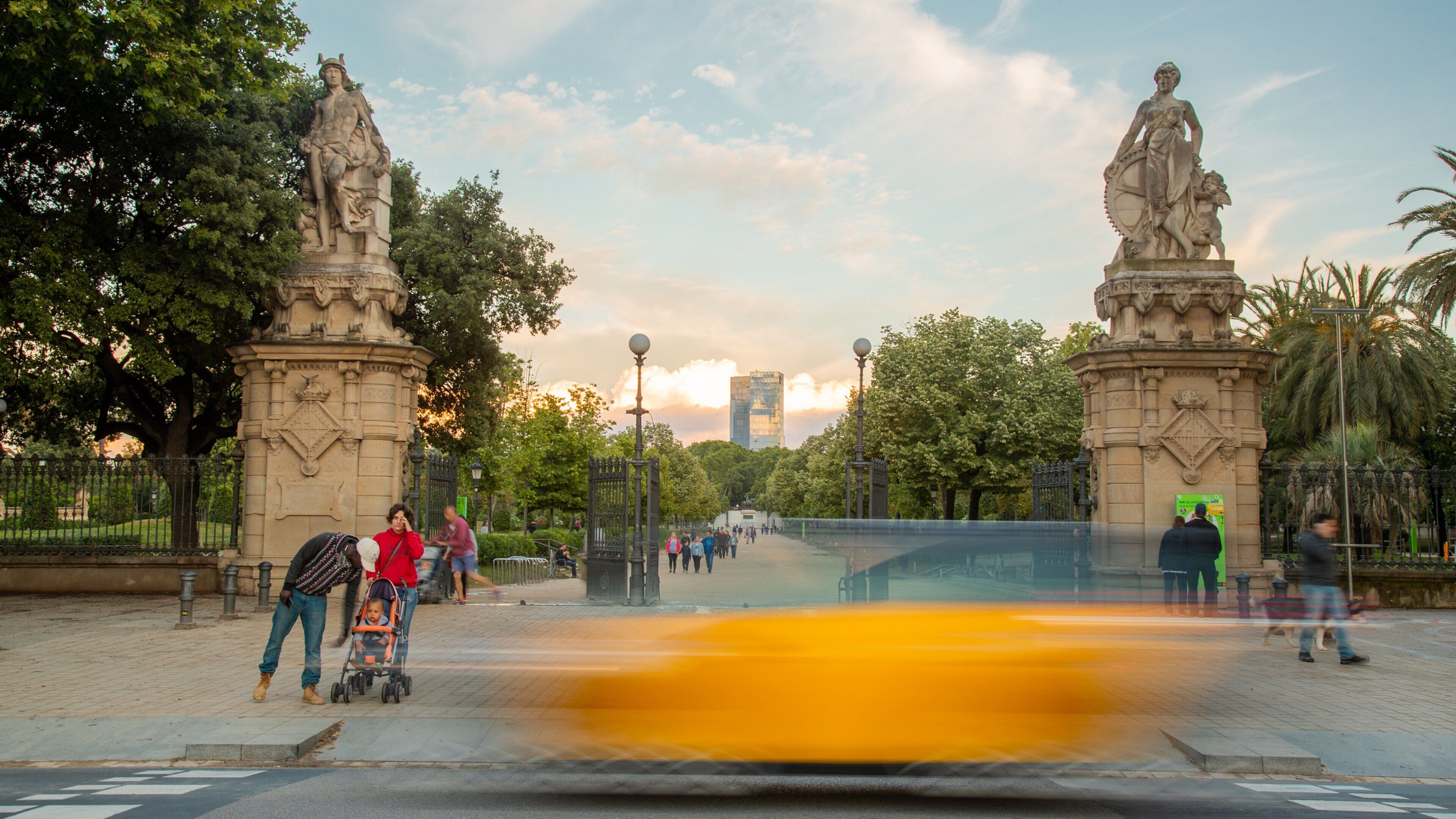 Parc de la Ciutadella which includes a sunset and a park as well as a family