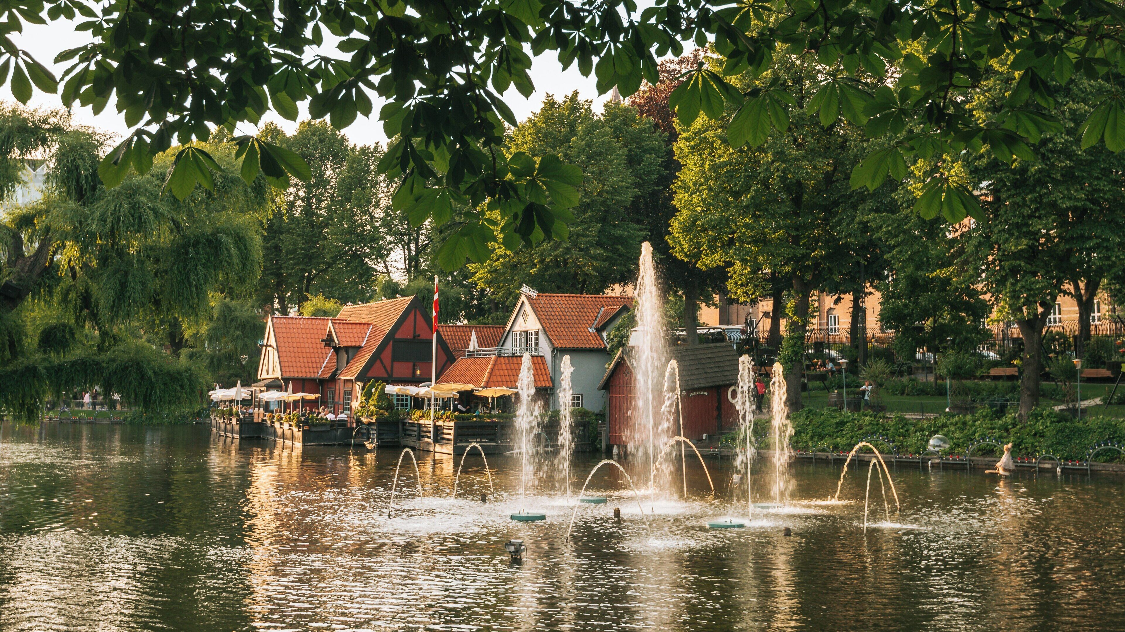 Enjoying the picturesque fountains and charming architecture at Tivoli Gardens in Copenhagen during a sunny afternoon