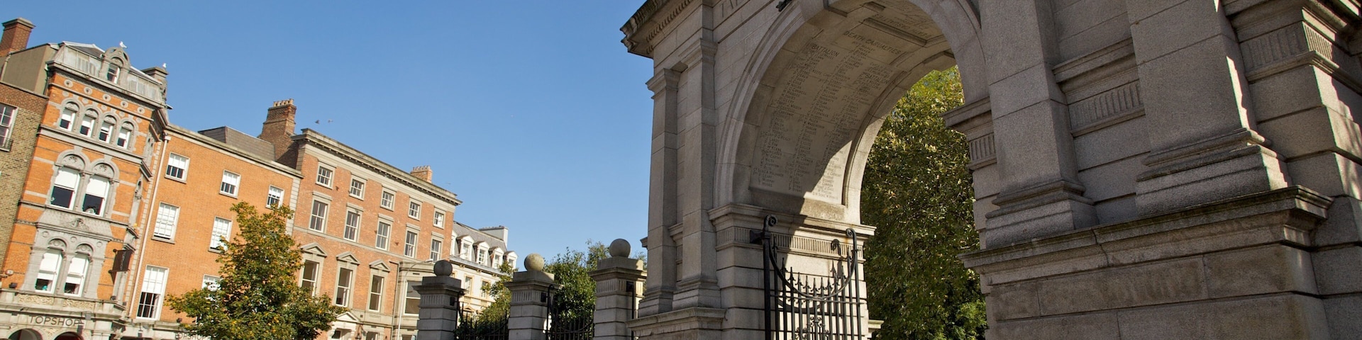 St. Stephen's Green in Dublin features visitors enjoying a sunny day near historic arches and vibrant surroundings