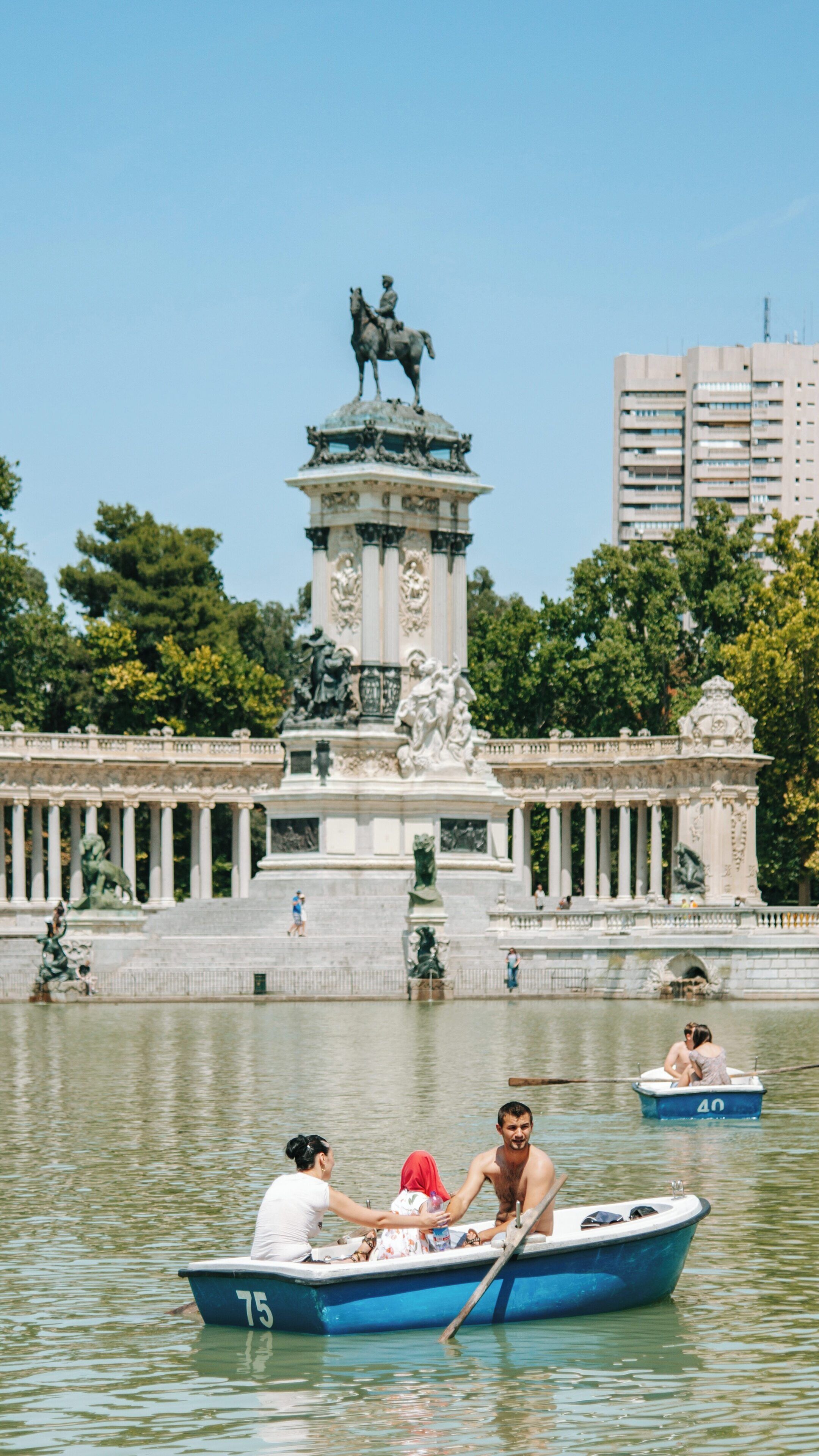 Boating in El Retiro Park, a serene day in Madrid's popular green space with families enjoying a leisurely afternoon on the water