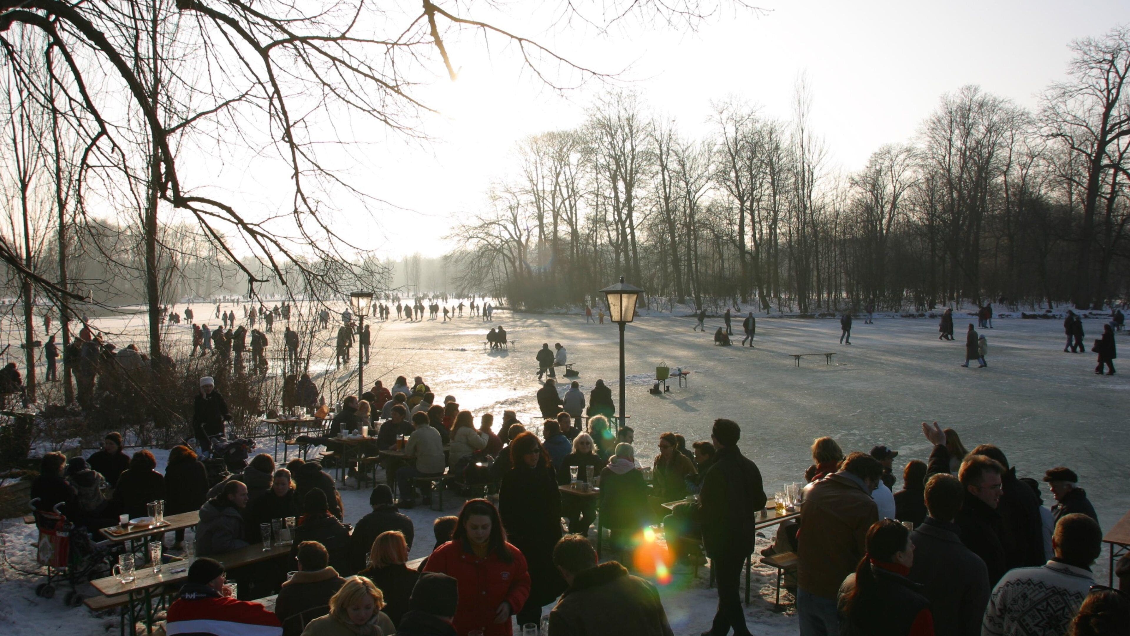 English Garden which includes snow and a sunset as well as a large group of people
