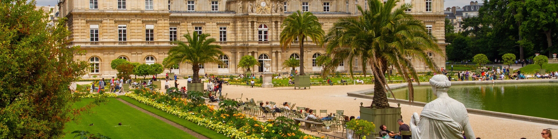 Visitors relax in the beautiful Luxembourg Gardens in Paris, enjoying the scenery and peaceful atmosphere